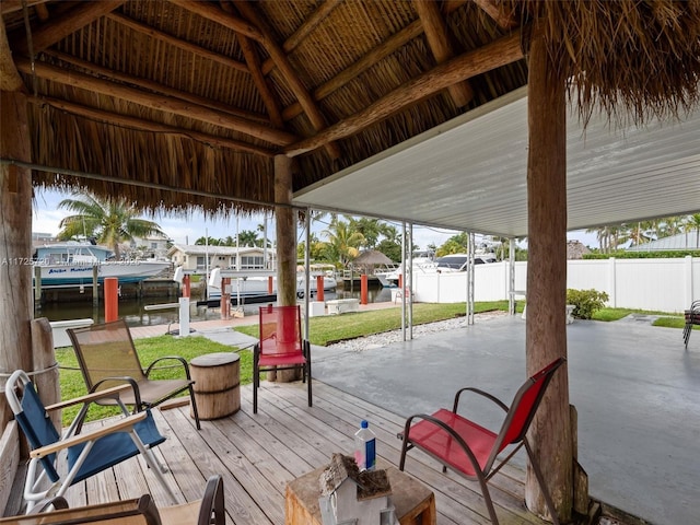 view of patio with a boat dock and a water view