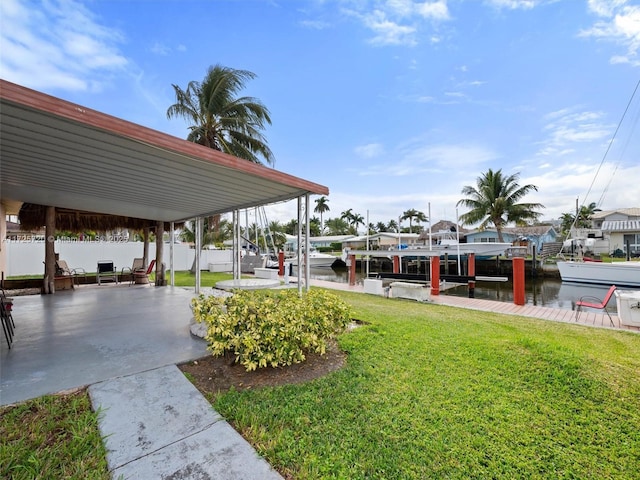 view of community with a water view, a lawn, and a boat dock