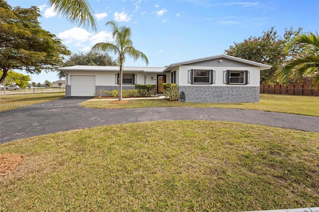 ranch-style house with a front lawn and a garage