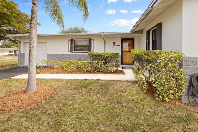 entrance to property with a yard and a garage