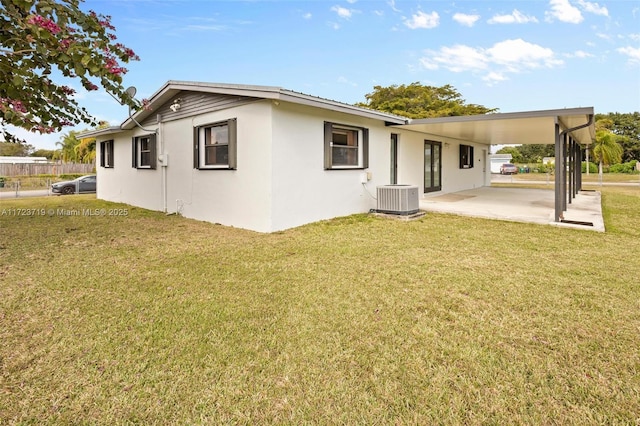 back of house with a patio area, central air condition unit, and a yard