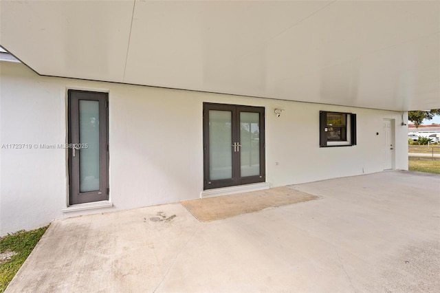 entrance to property with french doors and a patio area