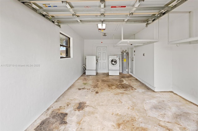 garage featuring water heater, washing machine and dryer, and refrigerator