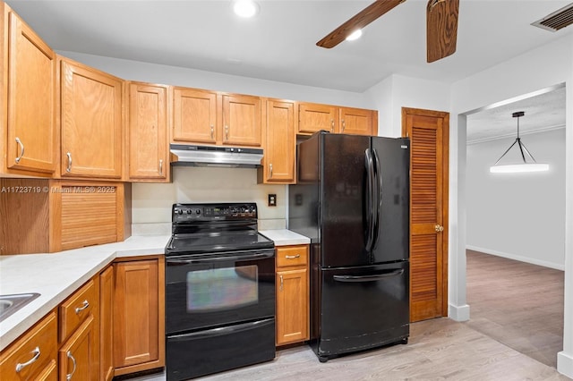 kitchen featuring black appliances, ceiling fan, pendant lighting, and light hardwood / wood-style floors