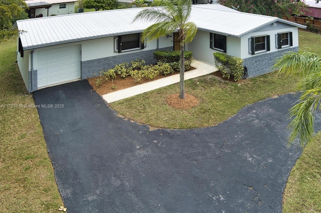 ranch-style home with a front yard and a garage