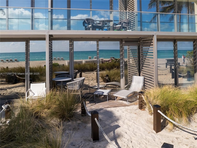 view of patio with a view of the beach and a water view