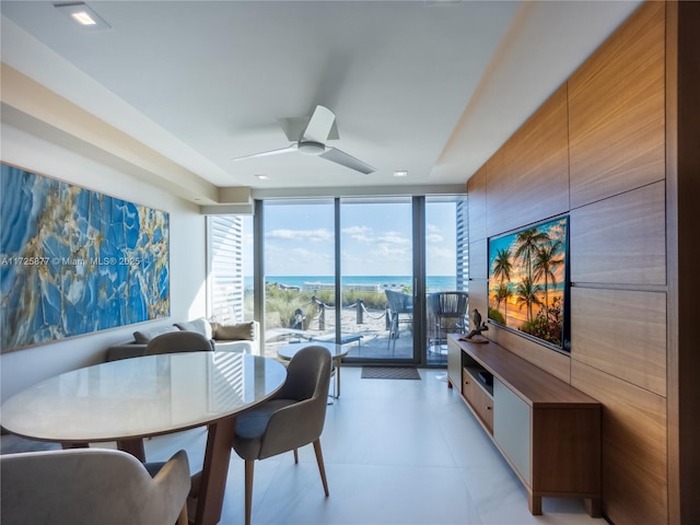 dining room featuring a wall of windows and ceiling fan