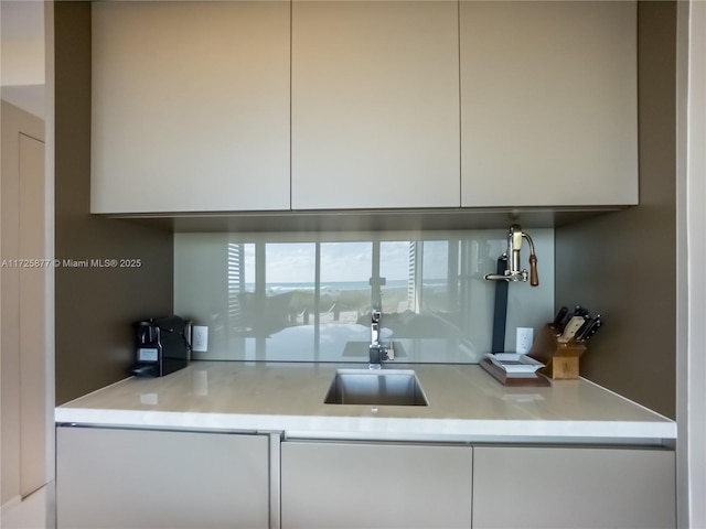 kitchen with sink and white cabinetry