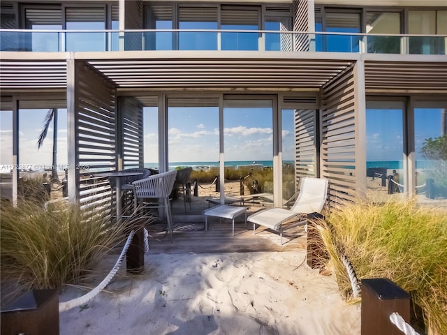 view of patio / terrace with a balcony and a water view