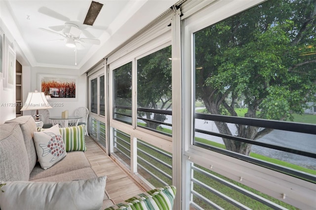 sunroom featuring ceiling fan