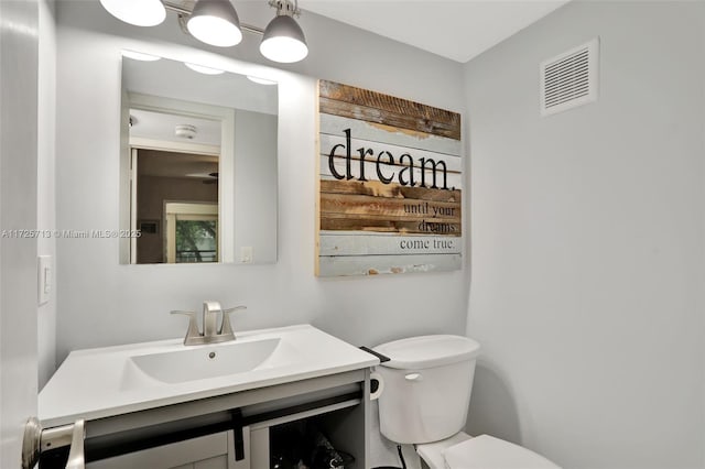 bathroom with toilet and vanity