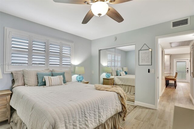 bedroom featuring ceiling fan, light hardwood / wood-style flooring, and access to exterior