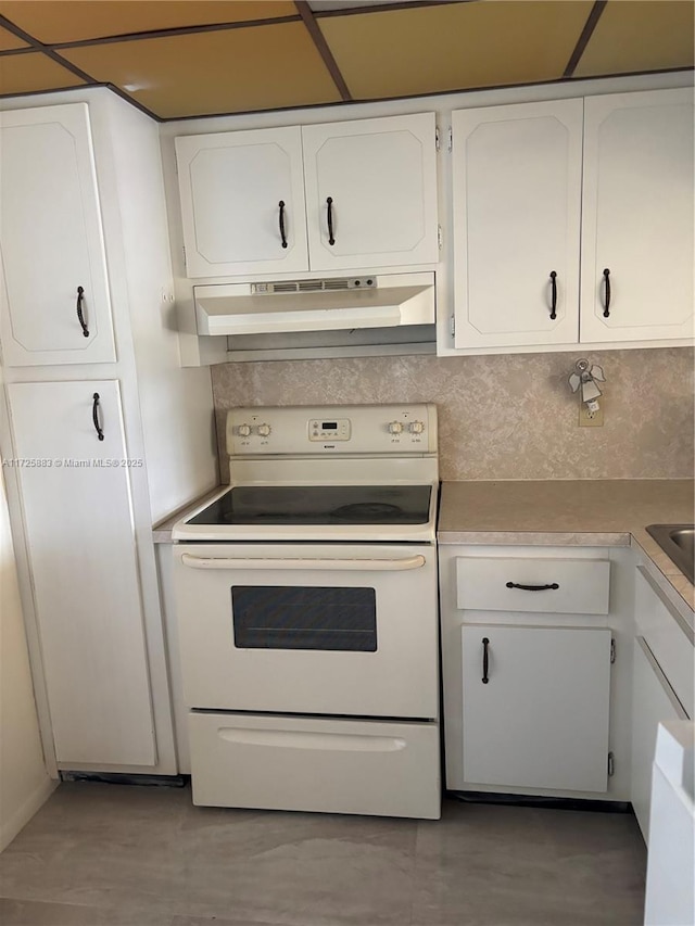 kitchen featuring white cabinets, backsplash, and electric stove