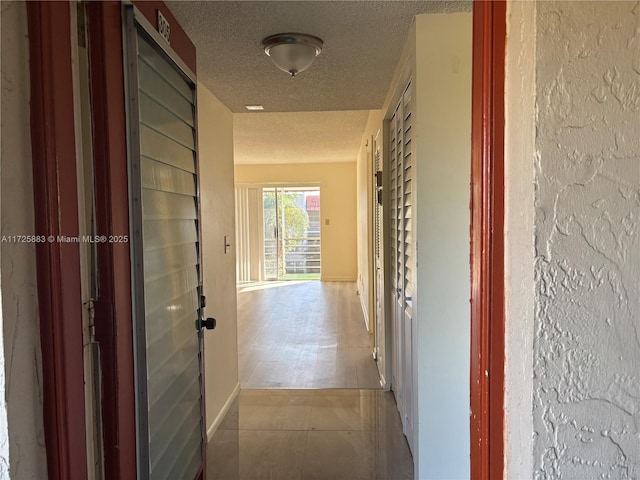 corridor featuring a textured ceiling