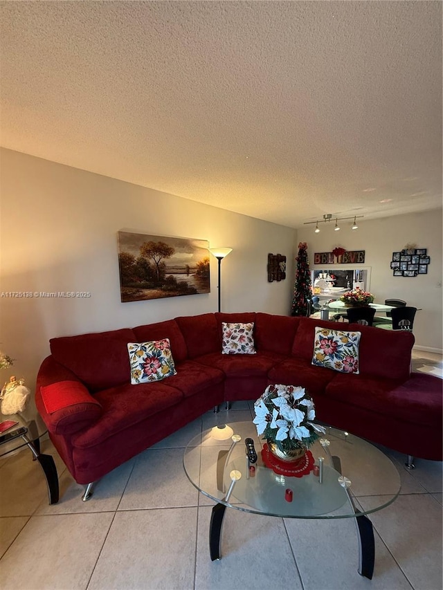 tiled living room featuring a textured ceiling