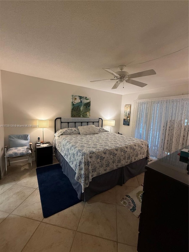 bedroom featuring light tile patterned flooring, a textured ceiling, and ceiling fan