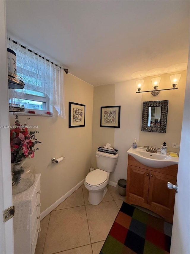 bathroom featuring tile patterned flooring, vanity, and toilet