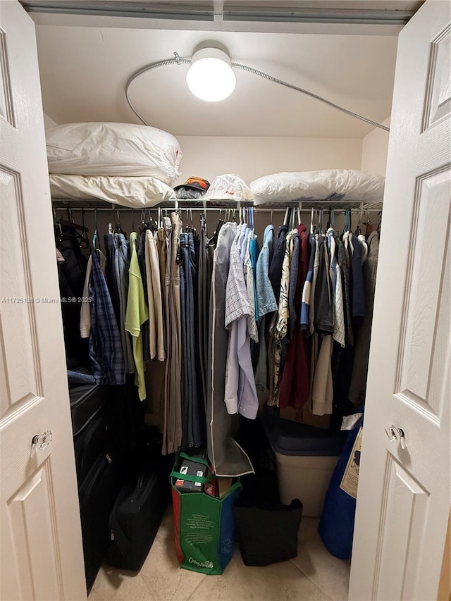 walk in closet with tile patterned floors