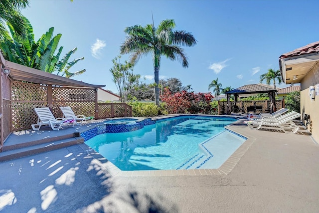 view of swimming pool featuring a gazebo, an in ground hot tub, and a patio