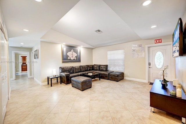 living room with light tile patterned flooring and vaulted ceiling