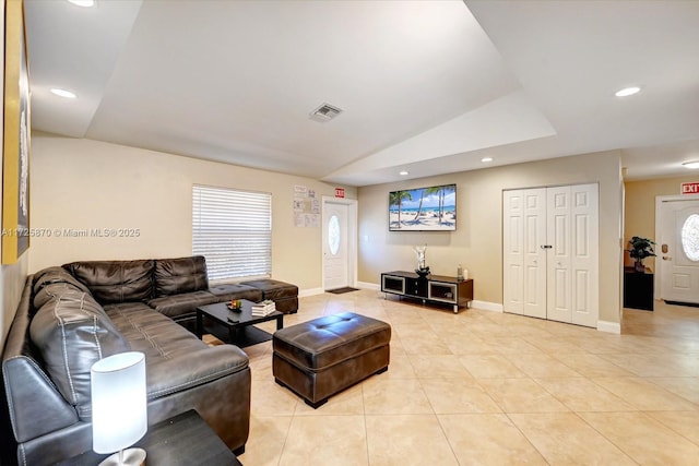 tiled living room featuring lofted ceiling