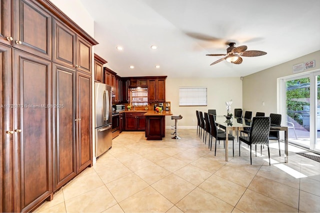 kitchen with stainless steel appliances, sink, ceiling fan, and light tile patterned floors