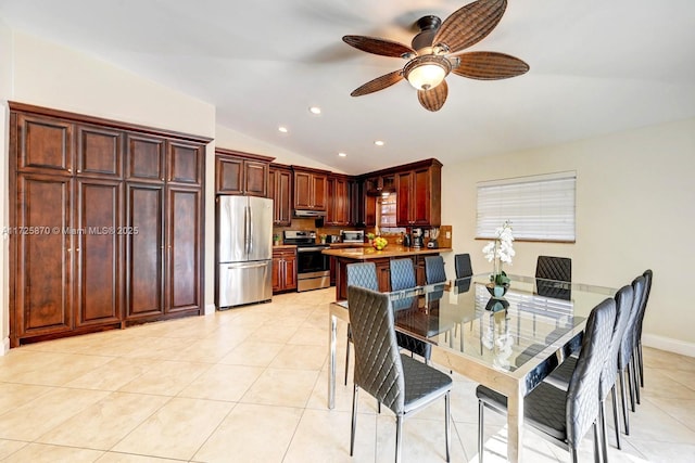 tiled dining room with lofted ceiling and ceiling fan