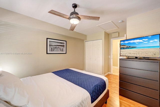 bedroom featuring ceiling fan, light wood-type flooring, and a closet