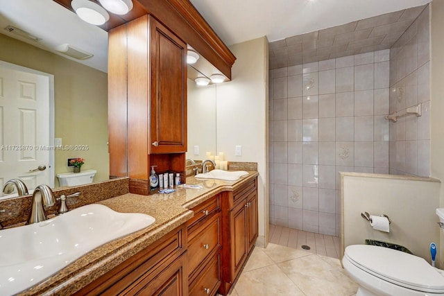 bathroom with tile patterned flooring, toilet, walk in shower, vanity, and tile walls