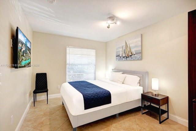 bedroom with light tile patterned floors