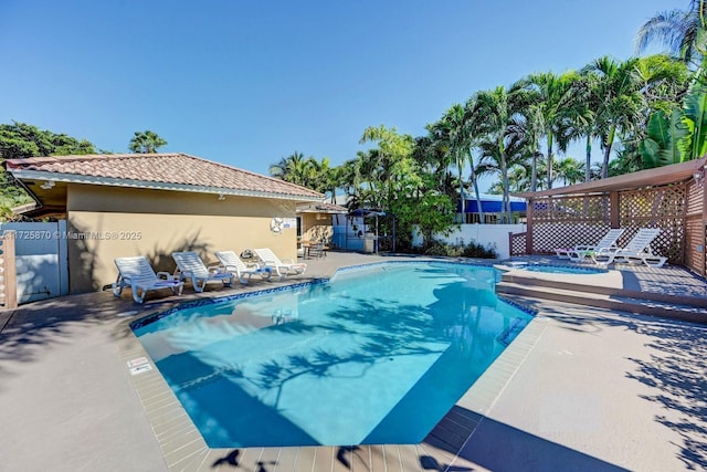 view of swimming pool with an in ground hot tub and a patio