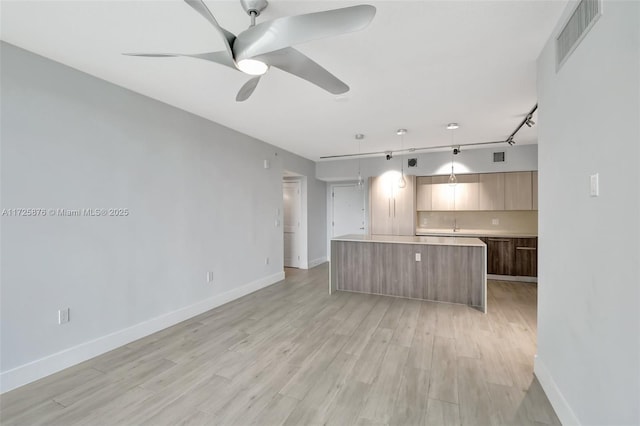 kitchen featuring decorative light fixtures, a center island, ceiling fan, light hardwood / wood-style floors, and track lighting