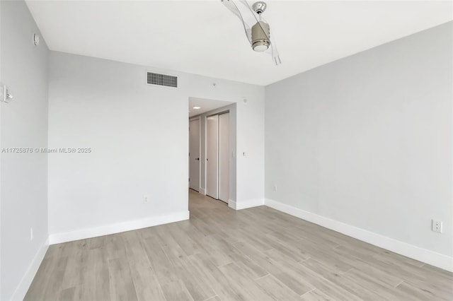 spare room with light hardwood / wood-style floors