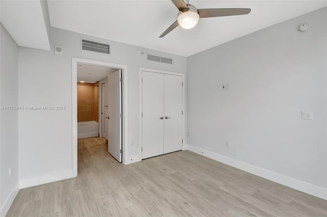 unfurnished bedroom featuring light wood-type flooring, ceiling fan, and a closet