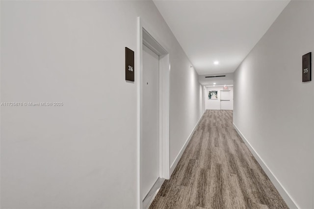 corridor with light wood-type flooring