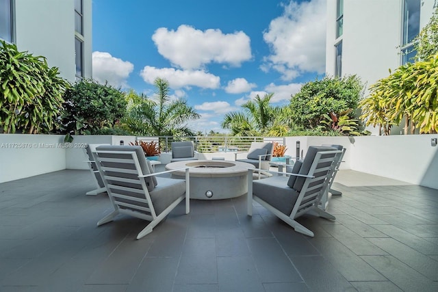 view of patio / terrace with an outdoor living space with a fire pit