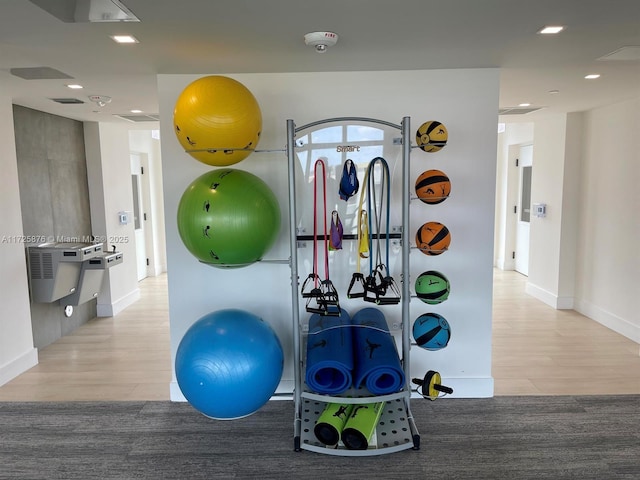 workout area with light wood-type flooring