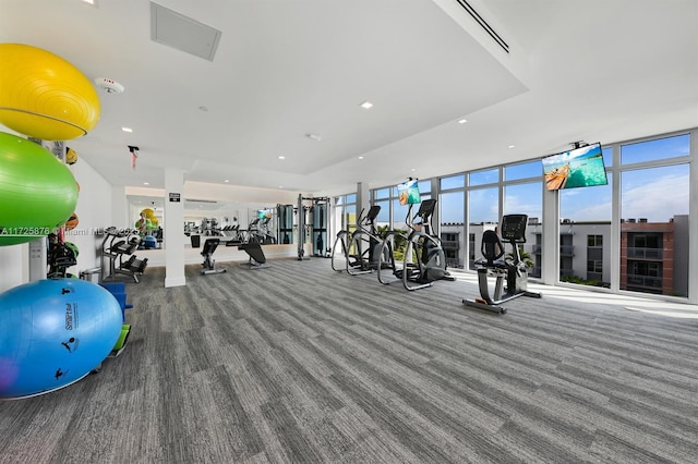 exercise room with expansive windows and carpet