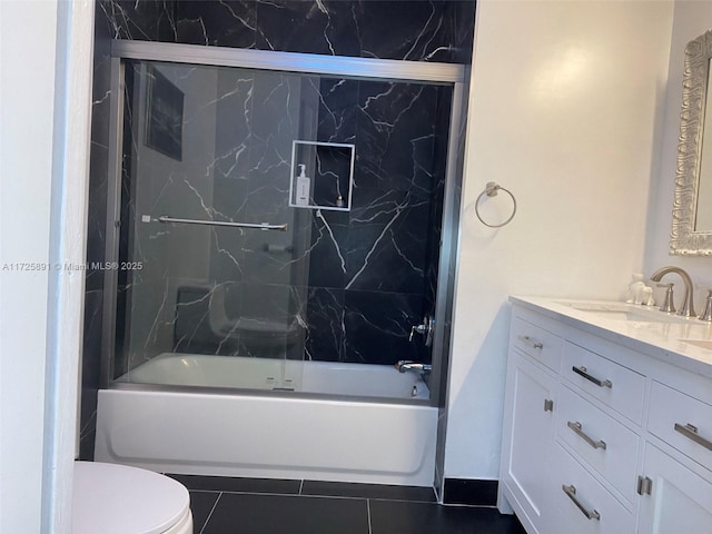 full bathroom with toilet, bath / shower combo with glass door, tile patterned floors, and vanity