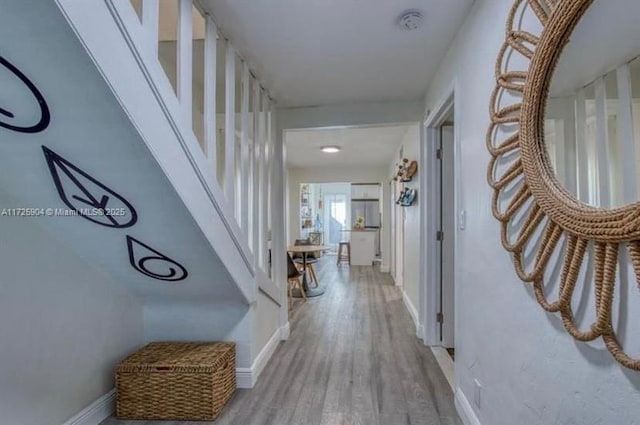 corridor with light hardwood / wood-style floors