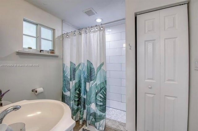 bathroom with sink and curtained shower