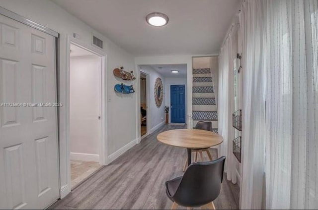 corridor with light hardwood / wood-style flooring