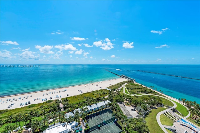 drone / aerial view featuring a water view and a view of the beach