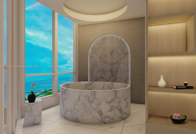 bathroom featuring a tub and a water view