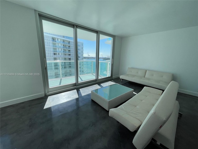 living room featuring a water view and a wall of windows