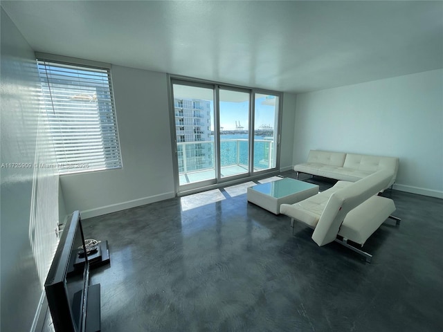 living room with a wall of windows and a water view