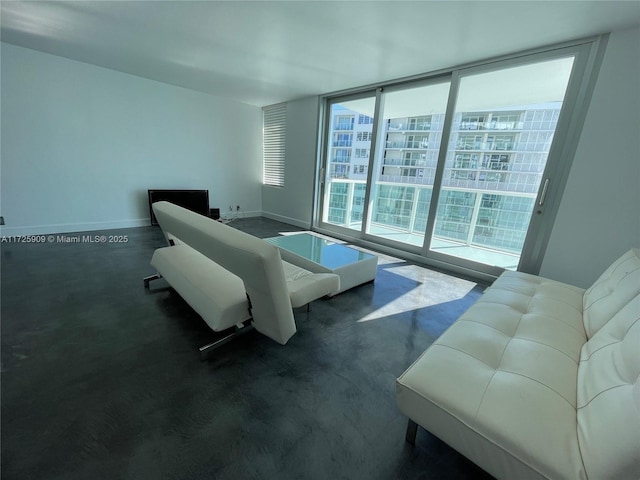 living room featuring plenty of natural light and floor to ceiling windows