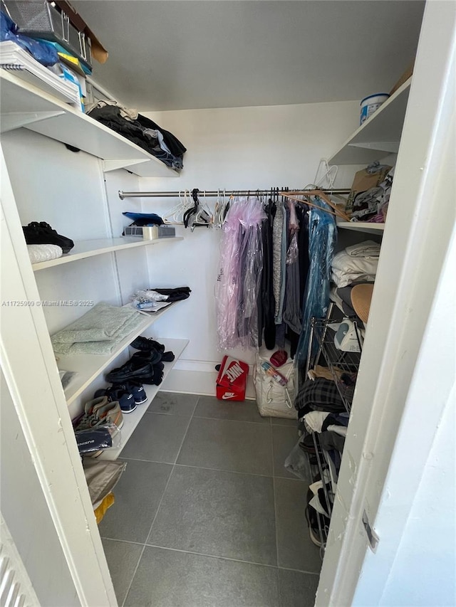 spacious closet with dark tile patterned flooring