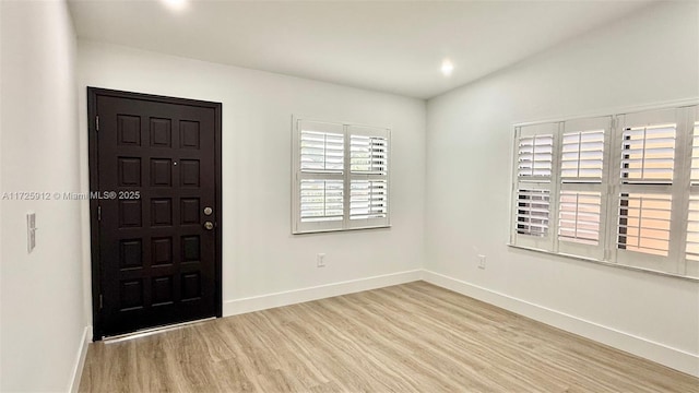 entrance foyer featuring recessed lighting, wood finished floors, and baseboards