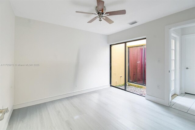 empty room with light wood-style flooring, a ceiling fan, and baseboards